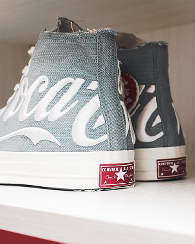 Kith x Coca-Cola colors on a white denim rendition of the classic Chuck Taylor All Star 70 sneakers