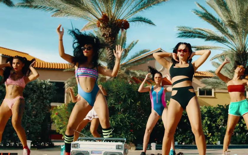 screenshot from up all night video of aerobic dancers in swimsuits