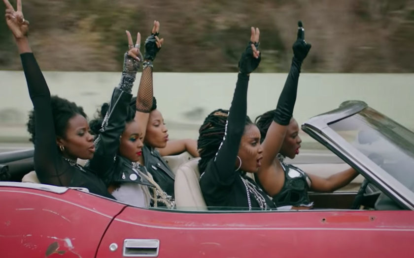screenshot from crazy classic life video janelle monae in red convertible with friends