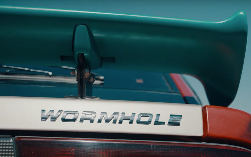 car that says wormhole on the back instead of usual brand name logo