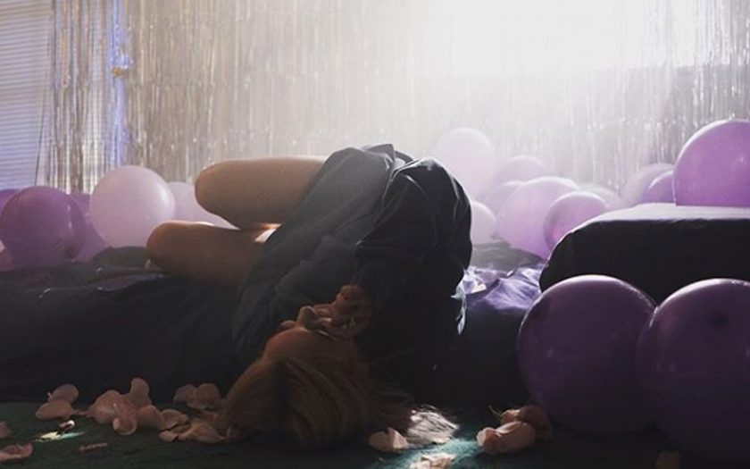 julia michaels lying on the floor with pink balloons and roses