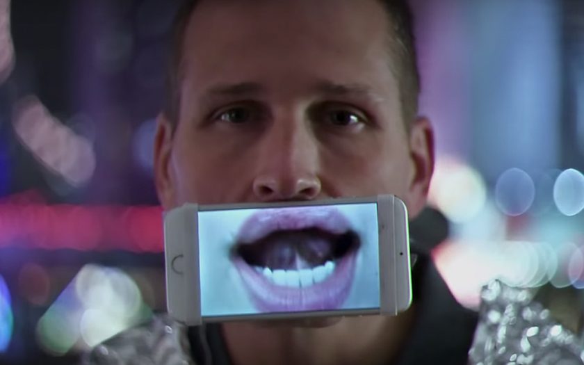 Kaskade holding a phone in front of his mouth