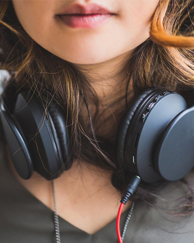 Super up close photo of a woman wearing headphones