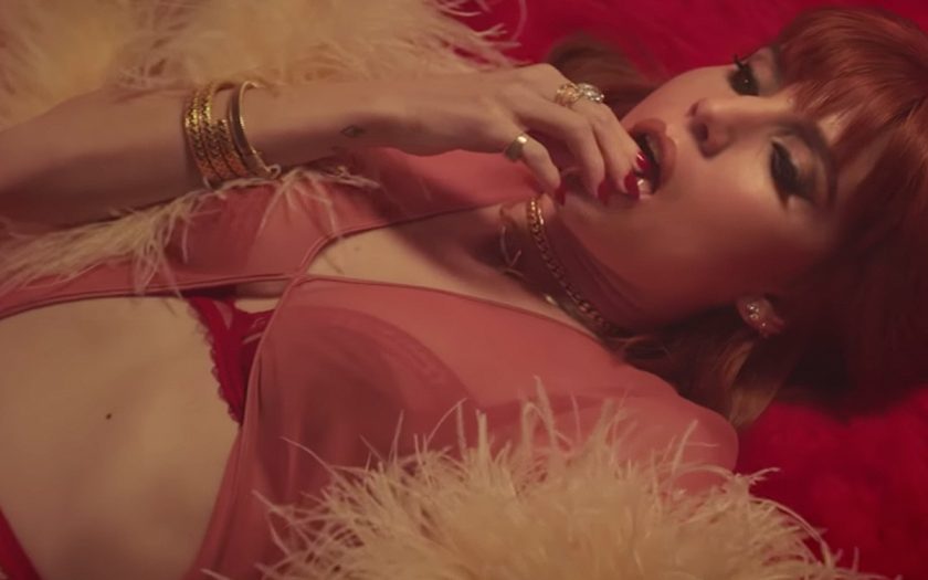 lykke li in red lingerie puts a square of something in her mouth in late night feelings music video