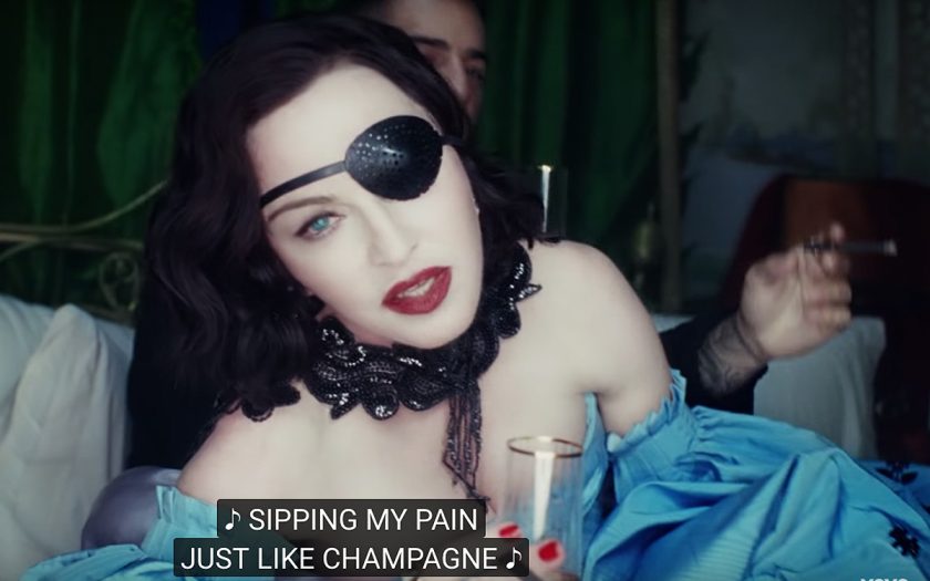 Madonna in Medellin video caption reads sipping my pain just like champagne