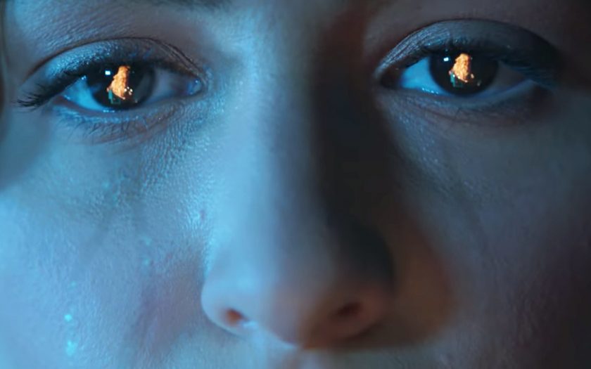 screenshot from here with me video, crying woman with fire reflected in eyes