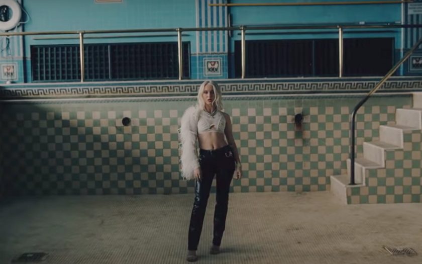 zara larsson stands in an empty swimming pool