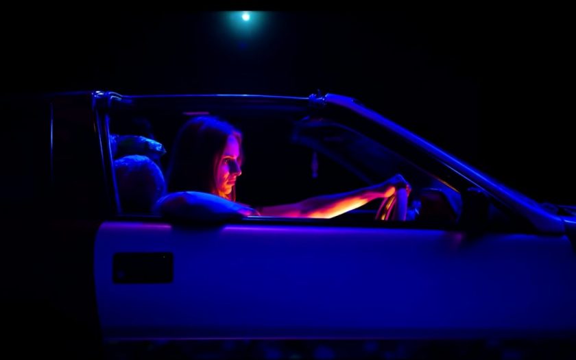 Vera Blue drive a car at night
