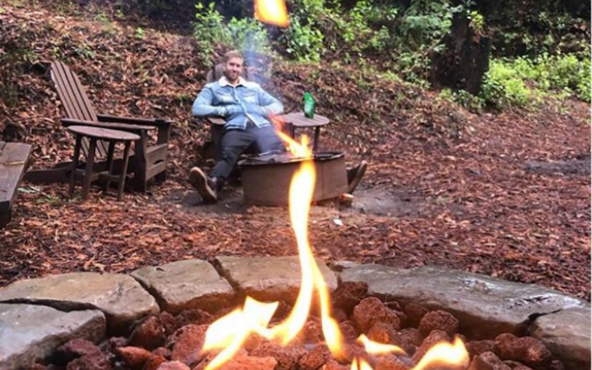 calvin harris enjoying a fire pit outdoors