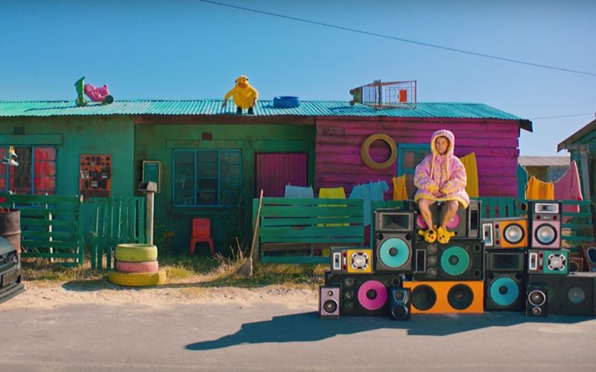 Yolandi sitting on a pile of speakers infront of south african shack in her PJ's