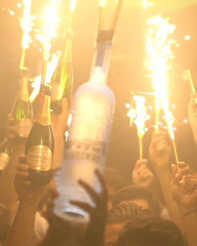popping bottles at sky room new york with a sparkler