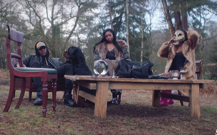 Rapper with two models and a dog at tea party in the forest